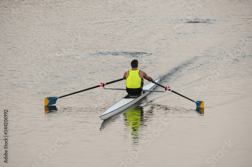 A single sculler (rower) in his racing shell