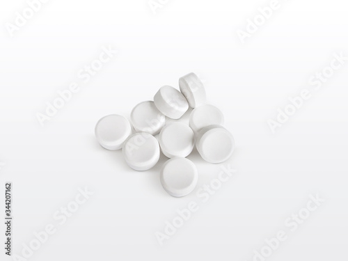 Heap of white painkiller tablets on white