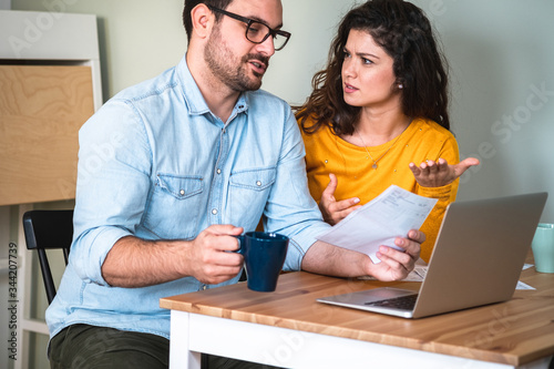 Worried unhappy couple arguing about debt or high domestic bills with laptop and documents stock photo © Tijana