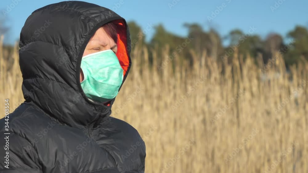 The depressed look of the woman on her hood and face mask in Finland The depressed look of the woman on her hood and face mask in Finland