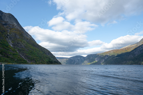 Fjords near Eidfjord with water and high mountains in southern Norway during autumn on a sunny day
