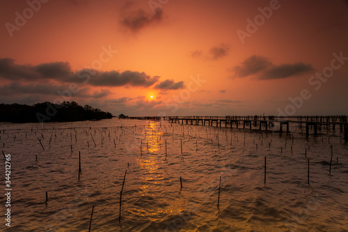 Tranquil scene of a pier in the sea with fog Small Dock and Boat at the lake  