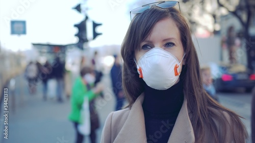 Coronavirus disease - woman wearing face mask in public to protect herself from the covid-19 virus.
