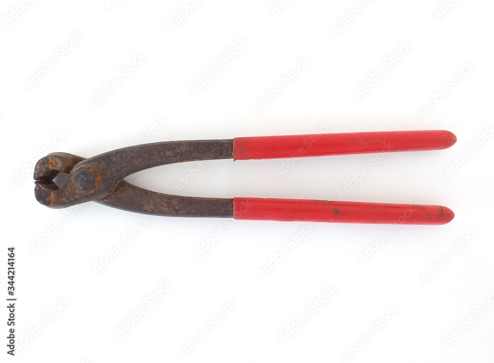 Aerial view old and rusty pliers with red handle in horizontal position isolated on white background. Close up of Old vintage rusty iron clamps. Aerial view old and rusty pliers with red handle in horizontal position isolated on white background. Close up of Old vintage rusty iron clamps.