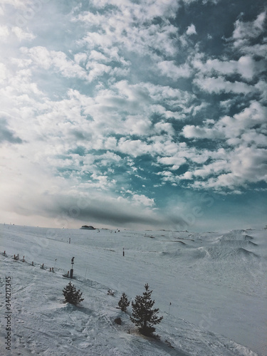 mountain top with snow, sky, clouds, ski-run and ski lift  © Cihat