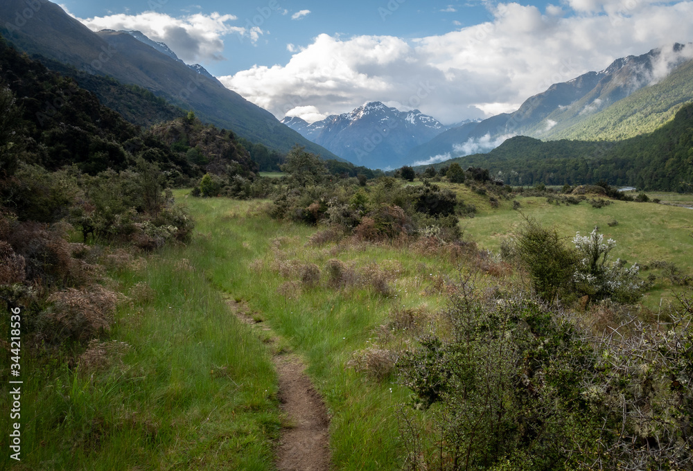 Picturesque alpine valley with dominant mountain on its end, shot on Caples Track, New Zealand