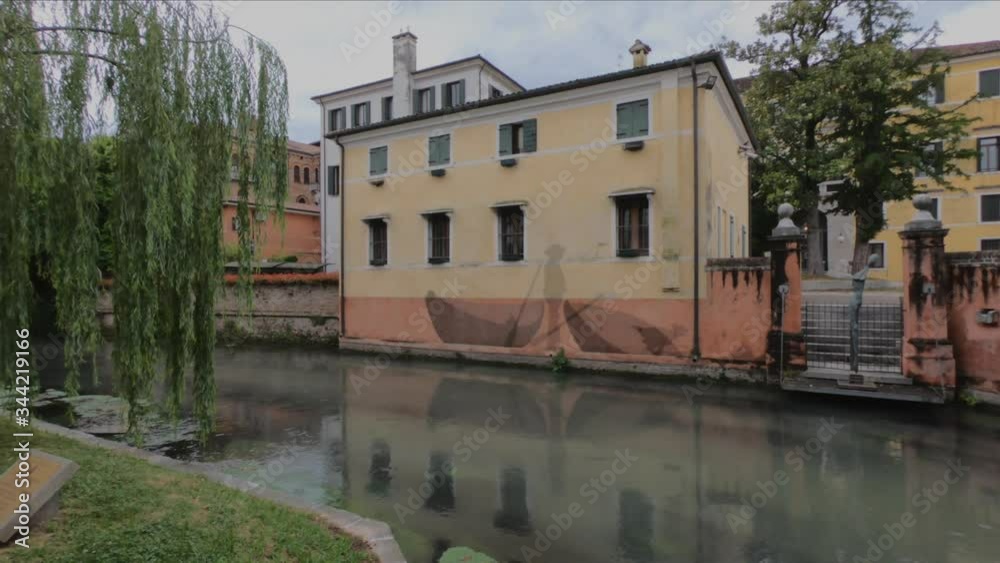 PAN SHOT SLOW MOTION - The Buranelli Canal is named after the merchants from Burano who lived along this watercourse in the 1500s, Treviso, Veneto, Italy. PAN SHOT SLOW MOTION - The Buranelli Canal is named after the merchants from Burano who lived along this watercourse in the 1500s, Treviso, Veneto, Italy.