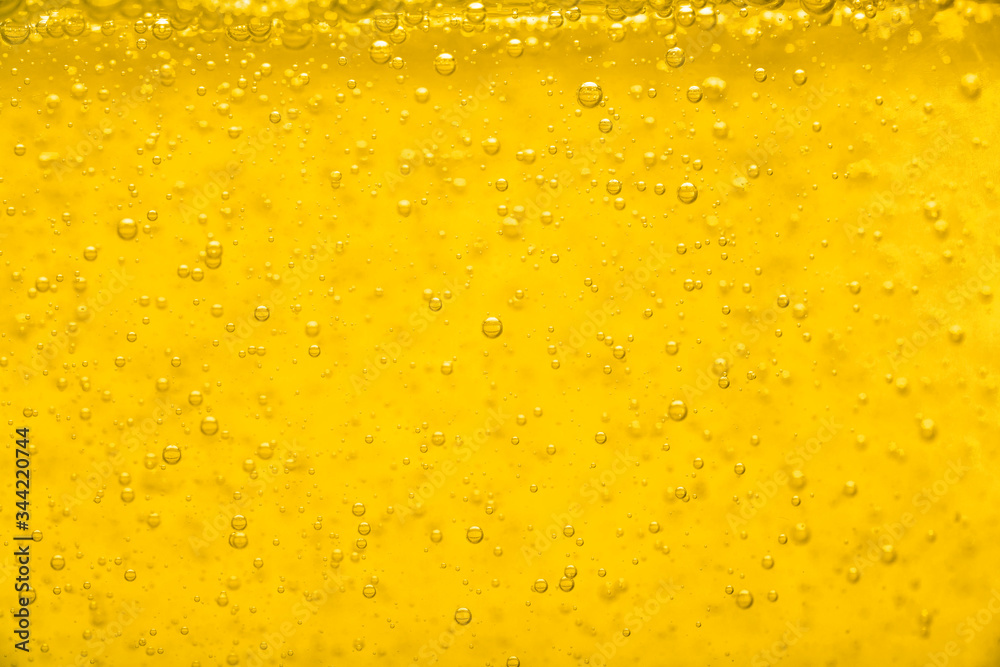 Gold  liquid bubble background with bubbles. Beer or vegetable oil background