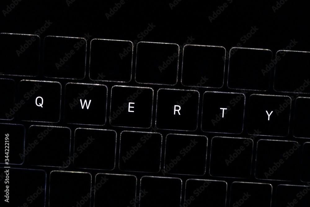 Obraz premium QWERTY. Night computer keyboard close up, keyboard light, dark theme bad password for your account 