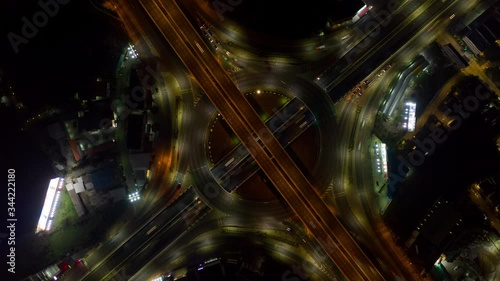 Hyperlapse timelapse zoom out of night city traffic on huge road intersection circle roundabout in Bangkok, thailand. 4K resolution aerial scene