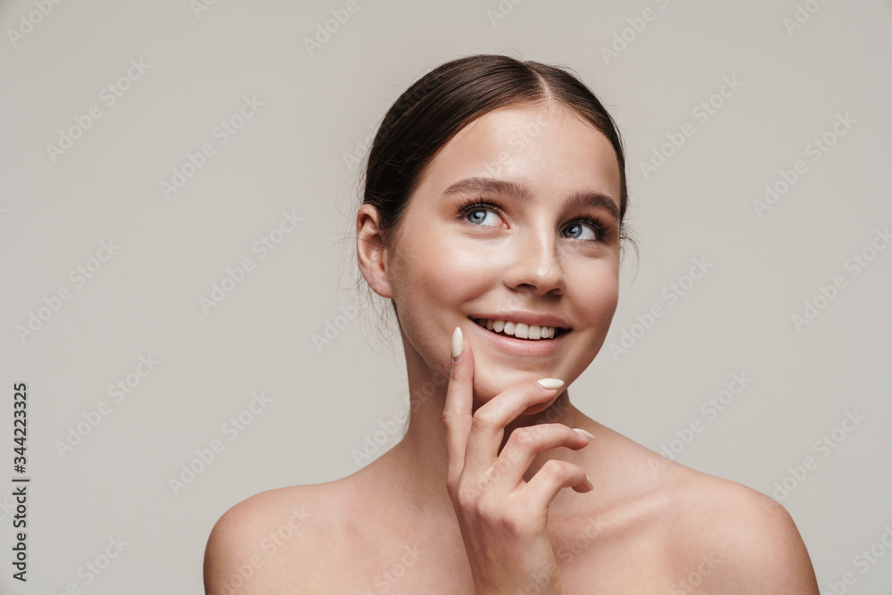 Image of happy nice shirtless woman smiling and looking upward Image of happy nice shirtless woman smiling and looking upward