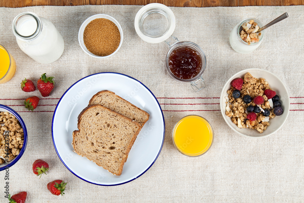 Healthy breakfast with toast, orange juice, cereal, milk, yogurt and strawberries. Copy space Healthy breakfast with toast, orange juice, cereal, milk, yogurt and strawberries. Copy space