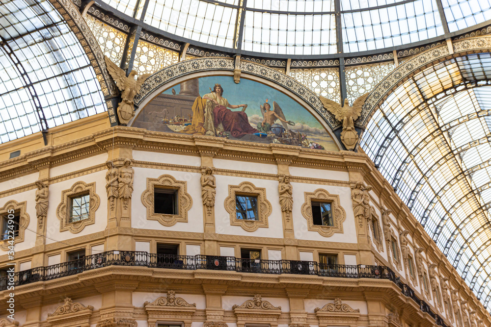 The interior of the Galleria Vittorio Emanuele II - Mall housed in a glass-covered 19th-century arcade with luxury clothing brands and upscale dining in Milan city, Italy