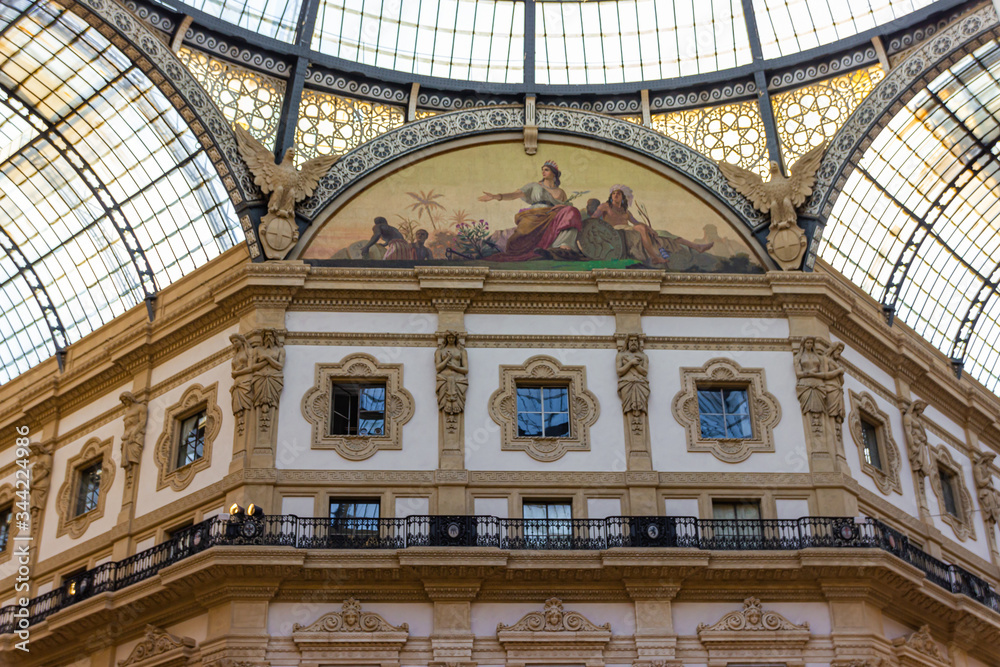 The interior of the Galleria Vittorio Emanuele II - Mall housed in a glass-covered 19th-century arcade with luxury clothing brands and upscale dining in Milan city, Italy