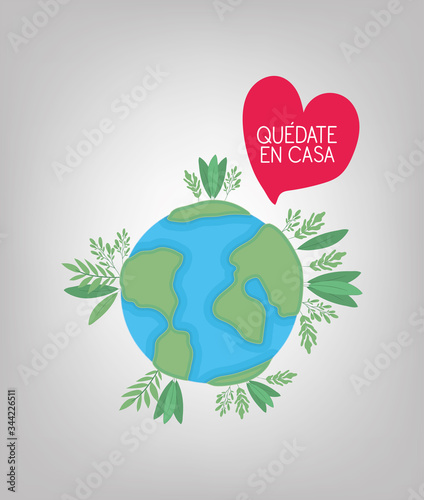 Quedate en casa text with world heart leaves vector design