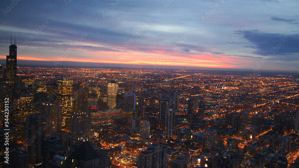 Obraz premium CHICAGO, ILLINOIS, UNITED STATES - DEC 11th, 2015: Aerial view of Chicago downtown at twilight from John Hancock skyscraper high above