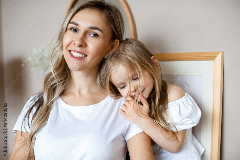 Mother's love. Mom hugs her little daughter. Maternal hugs. Female portraits close-up. The concept of female happiness Mother's love. Mom hugs her little daughter. Maternal hugs. Female portraits close-up. The concept of female happiness