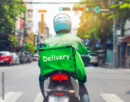 Food delivery drivers are driving to deliver products to customers who order online. Impact of epidemics photo