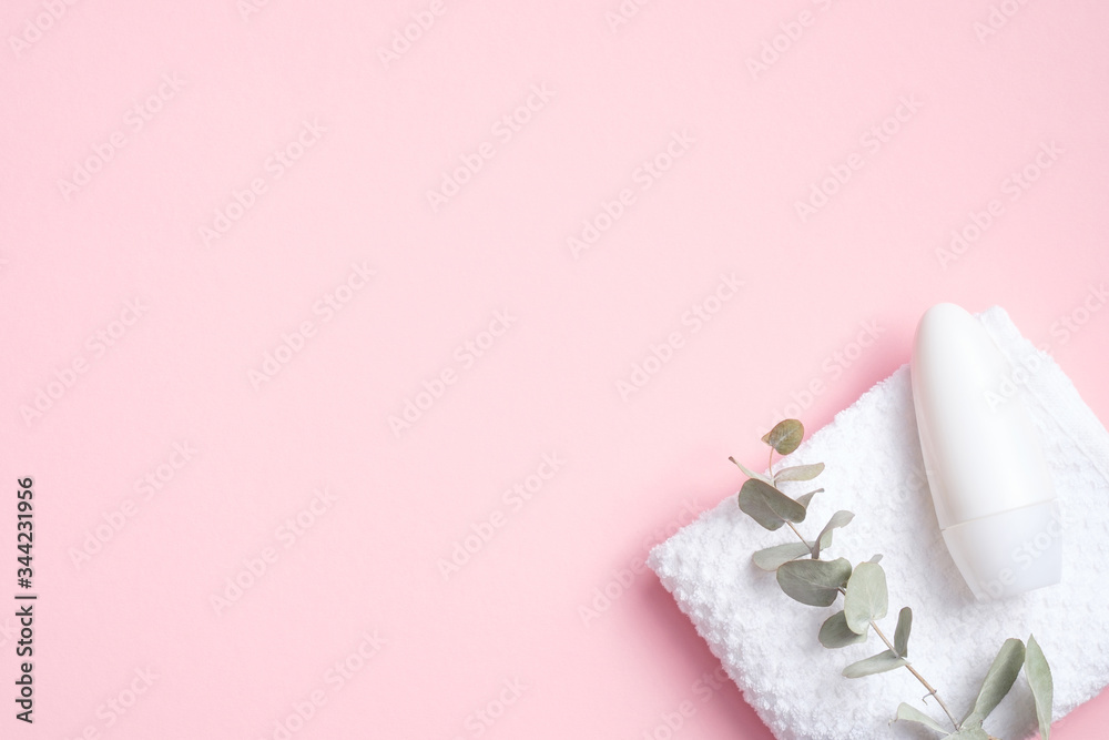 Blank roll-on deodorant bottle with eucalyptus and towel on pink background. Natural organic antiperspirant, sweat protection concept. Flat lay, top view Blank roll-on deodorant bottle with eucalyptus and towel on pink background. Natural organic antiperspirant, sweat protection concept. Flat lay, top view