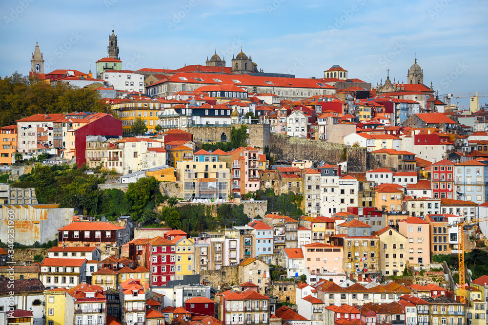Porto, The Ribeira District, Portugal old town ribeira view with colorful houses, traditional facades, old multi-colored houses with red roof tiles, standing on Douro river embankment.
