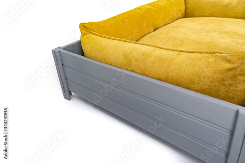 Yellow sofa for dogs and cats in a wooden box stand on the bottom