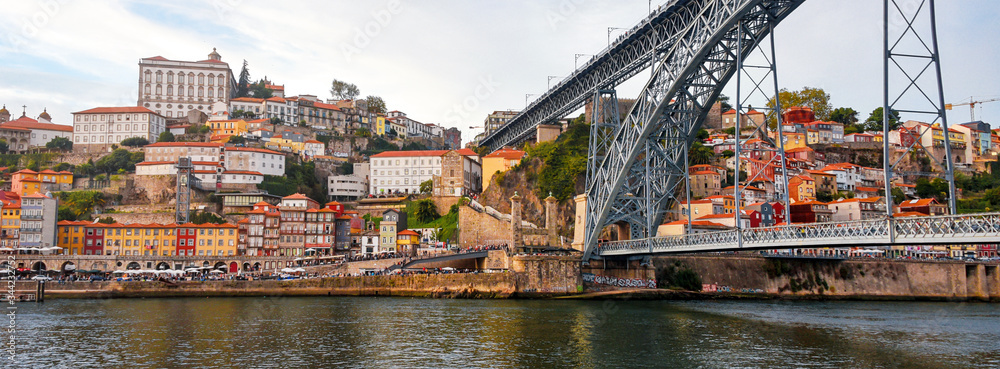 Porto, The Ribeira District, Portugal old town ribeira view with colorful houses and Luis I Bridge - a metal arch bridge over Douro River. Symbol of the city and a most popular touristic attraction