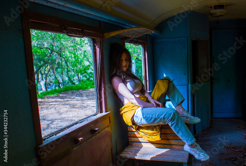 young woman sitting on a train, sexy young girl sitting on a train, young woman sitting on a chair in train