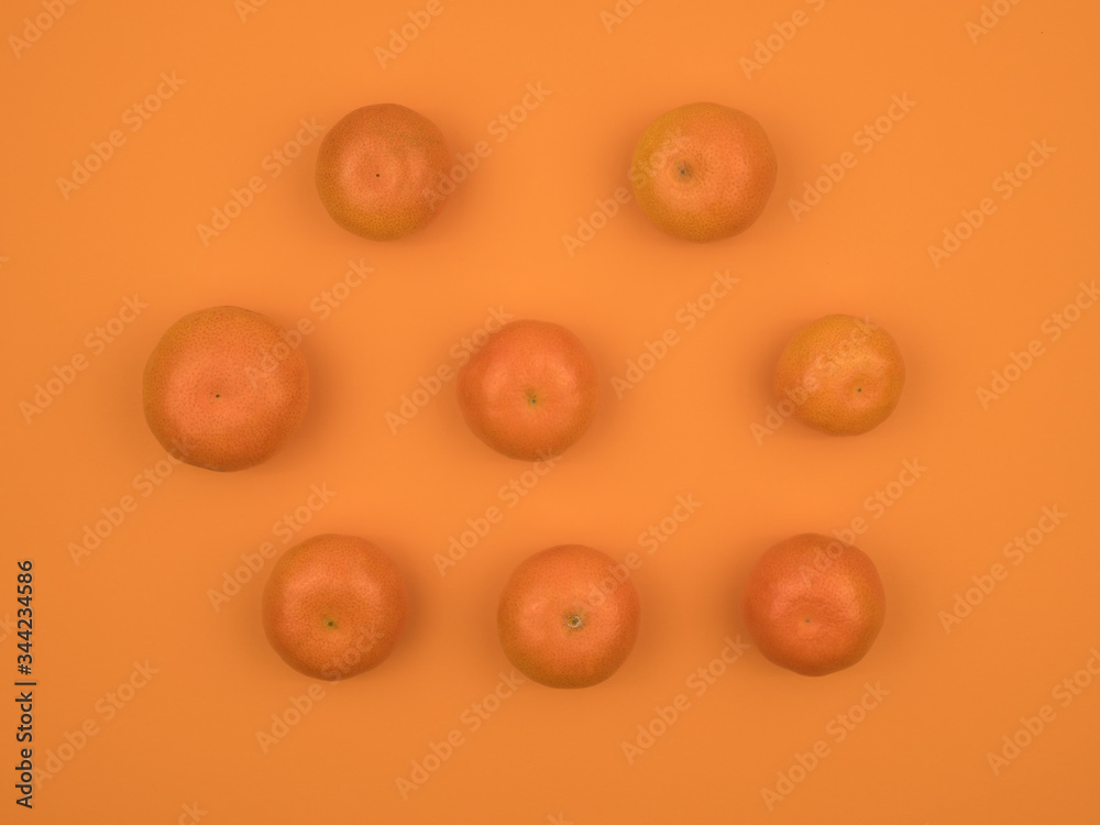 Ripe tangerine on an orange background. Citrus fruits. Ripe tangerine on an orange background. Citrus fruits.