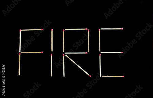 Fire writing made by matches sticks on black backgroung