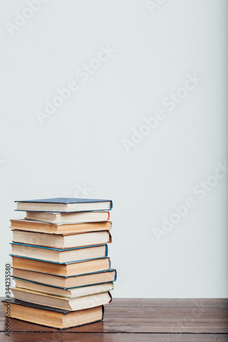 a lot of stacks of educational books for college on a white background