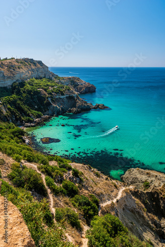 boats on Baunty beach, cape Fiolent in Balaklava, Sevastopol, Russia. View from the top of the rock. azure sea, sunny day clear sky background. The concept of perfect place for summer travel and rest photo