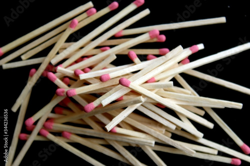 Pile of several matchsticks on black background