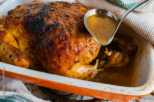 Hot baked chicken with a delicious brown fried crust. Cooked fried poultry, watering with its own juice and fat. Rich orange color of meat.