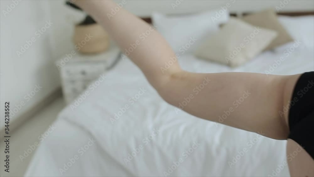 Young beautiful girl practices yoga doing exercises at home in a beautiful sports bra and underpants. Close-up