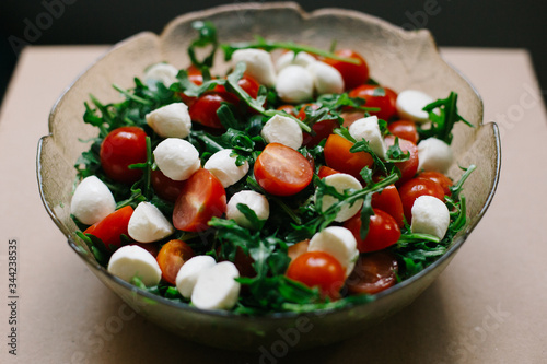 salad of fresh small tomatoes, arugula leaves and cheese © nastya_shemet