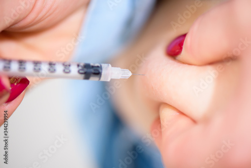 Diabetes patient insulin shot by syringe with dose of lantus  subcutaneous abdomen vaccination isolated on a white background