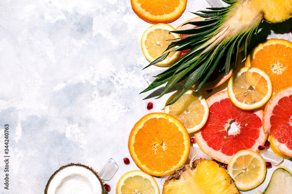 Tropical fruits pineapple, orange, lemon, coconut on a concrete background. Copy space Tropical fruits pineapple, orange, lemon, coconut on a concrete background. Copy space