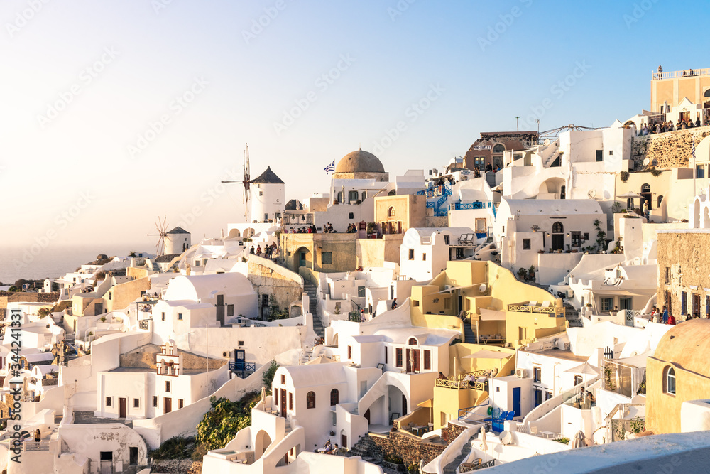 Sunset view of Oia with windmill, Santorini island, Cyclades, Greece