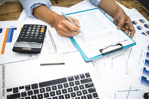 Hand business Writing tax on desk about at home office
