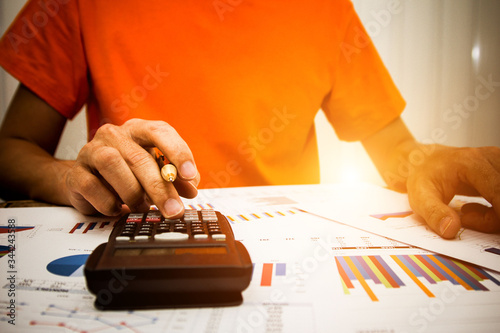 businessman using calculator and holding money for calculate tax in office.