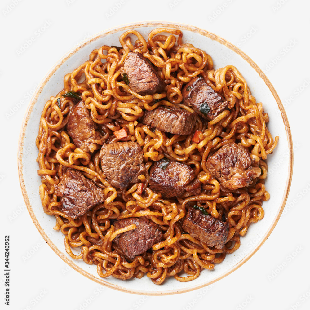 Ram-Don or Chapaguri noodles with beef steak in bowl isolated on white background. Jjapaguri is a popular south korean dish with ramen and udon noodles and beef steak. Ram-Don or Chapaguri noodles with beef steak in bowl isolated on white background. Jjapaguri is a popular south korean dish with ramen and udon noodles and beef steak.