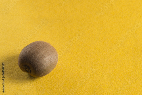 Ripe kiwi on a yellow background.