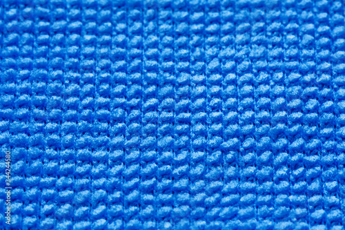 Blue knitted sweater background wallpaper. Fabric abstract texture. Selective focus.