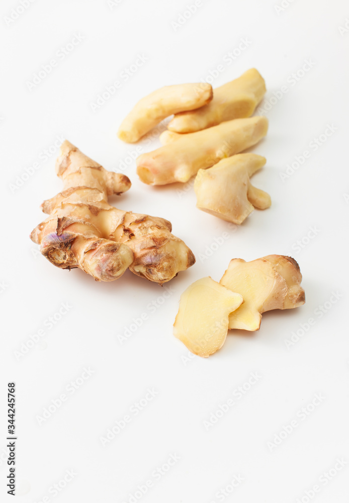 Cut and peeled young ginger root on a white background Cut and peeled young ginger root on a white background