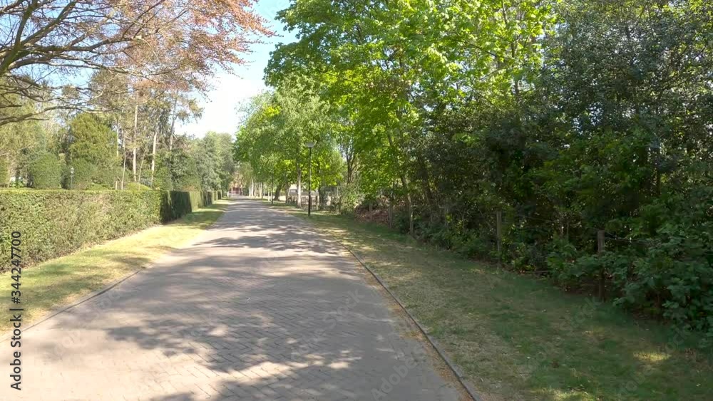 POV driving through Dutch village Blaricum with high class house in the street called Enghlaan POV driving through Dutch village Blaricum with high class house in the street called Enghlaan