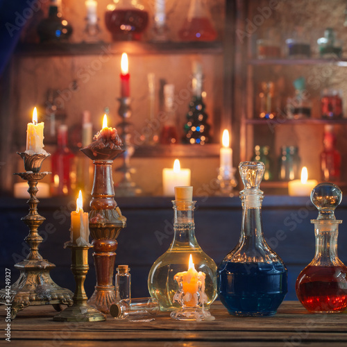magic potions in bottles on wooden background