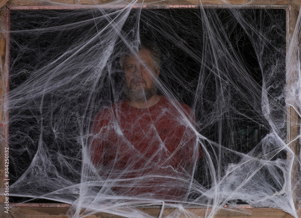 Naklejka premium man in a white spider web on a black background