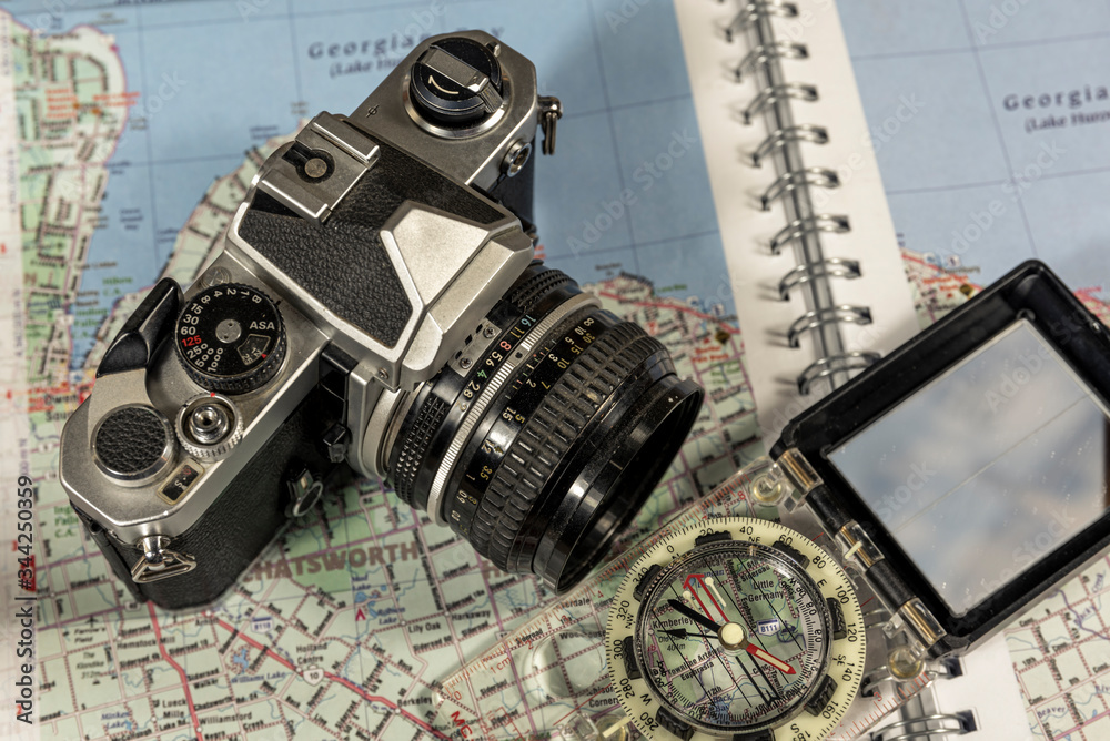 Vintage 35mm film camera with map and compass 
