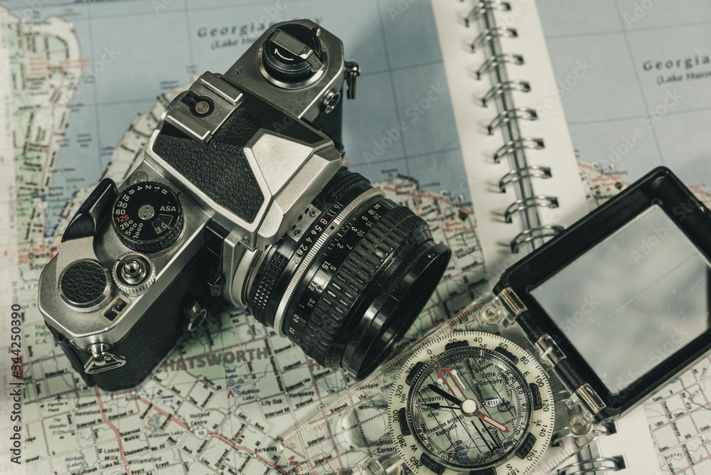 Vintage 35mm film camera with map and compass  (with vintage film style processing)