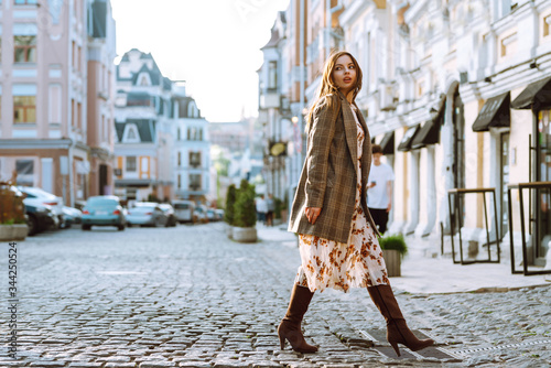 Attractive woman walking on the city street, relaxing on sunny day, Spring girl. Lifestyle concept.